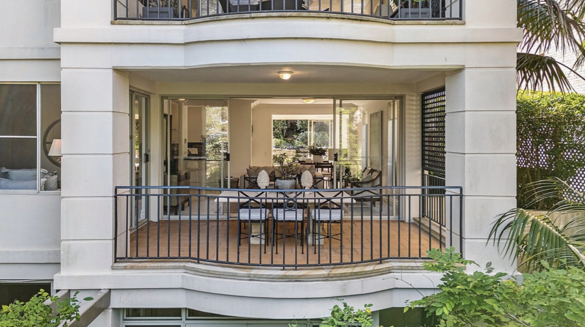 Modern apartment with balcony and dining area, viewed through glass doors—ideal for Buyers Agent seaforth clients.