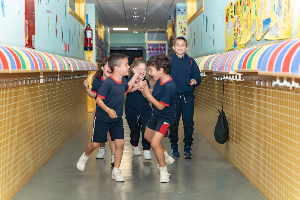 Happy children in uniform in a school in Fairlight